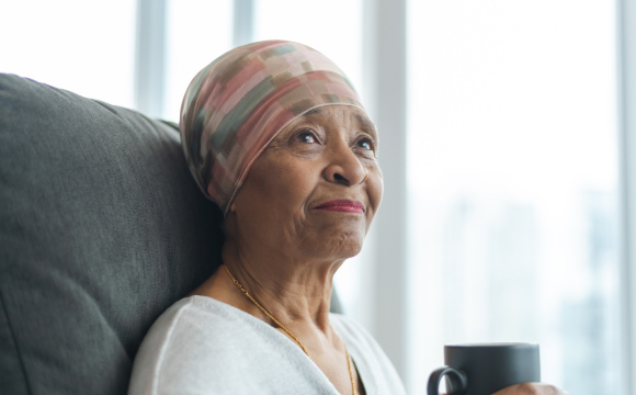 Elderly woman with a slight smile looks up pensively